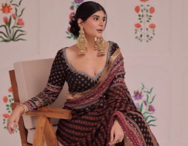 Veeriva maroon bandhani saree with black full sleeve blouse worn by a woman
